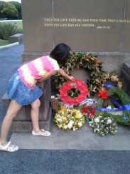 A girl laying a wreath at a memorial